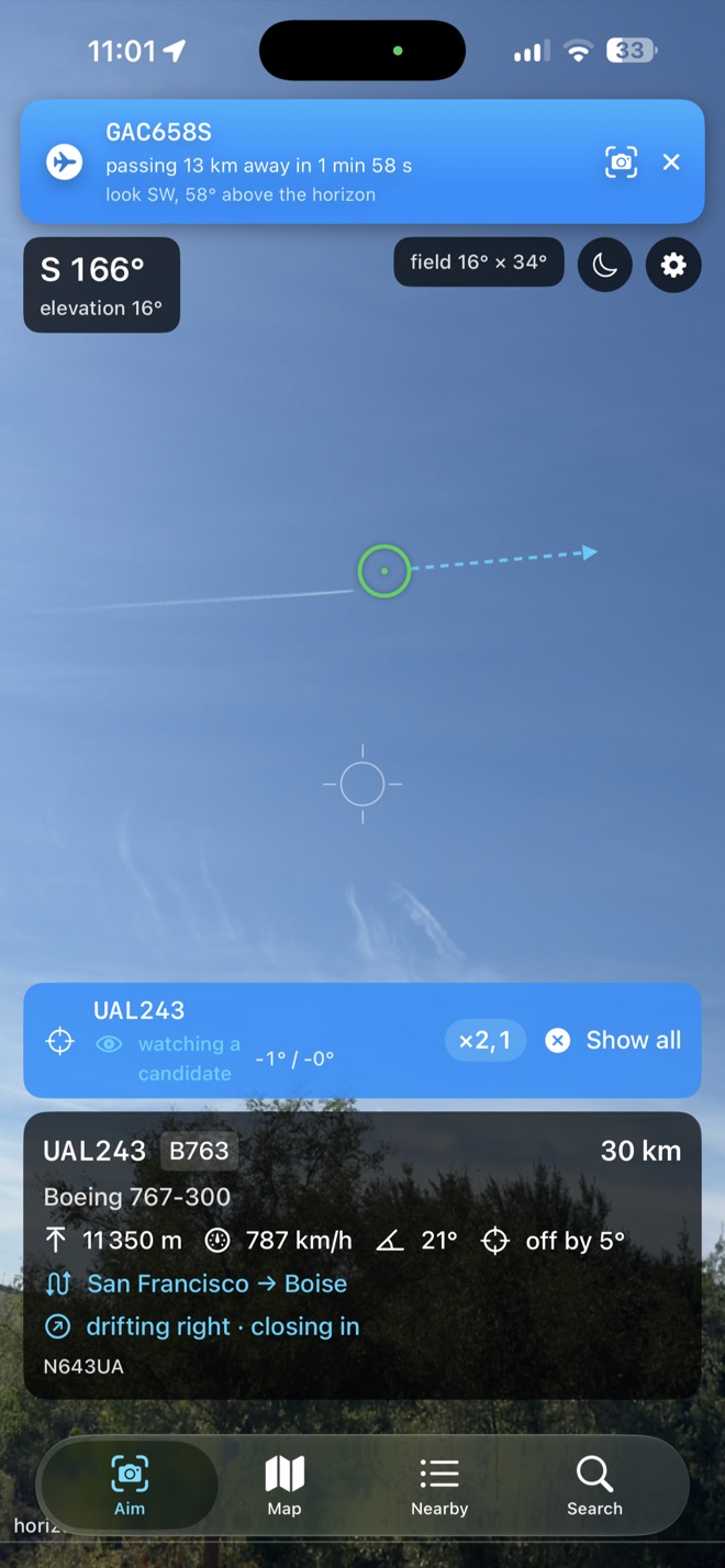 The SpotFlight camera view: a green circle sits on a distant airliner at the head of its contrail, with a card reading UAL243, Boeing 767-300, 30 km, San Francisco to Boise.